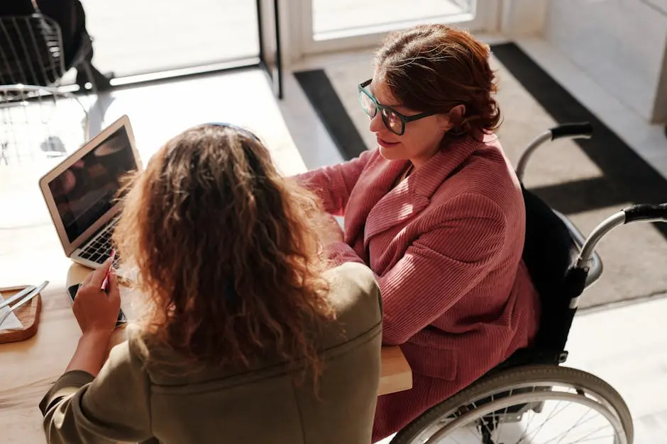 woman in a wheelchair and another woman working together